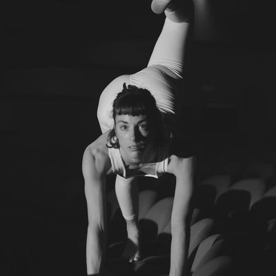 A person performing a dynamic stretching movement.